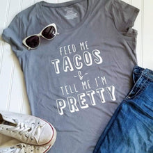 Load image into Gallery viewer, Funny &#39;Feed Me Tacos &amp; Tell Me I&#39;m Pretty&#39;  T-shirt for her Made in USA. Feed me tacos and tell me I&#39;m pretty T-shirt is perfect for your Taco lover who craves a few extra strokes!  Really, who doesn’t love tacos and ticklin’ the ego!!! **This shirt runs true to size, however, if you like a looser feel order a size up.  Bella Canvas Unisex
