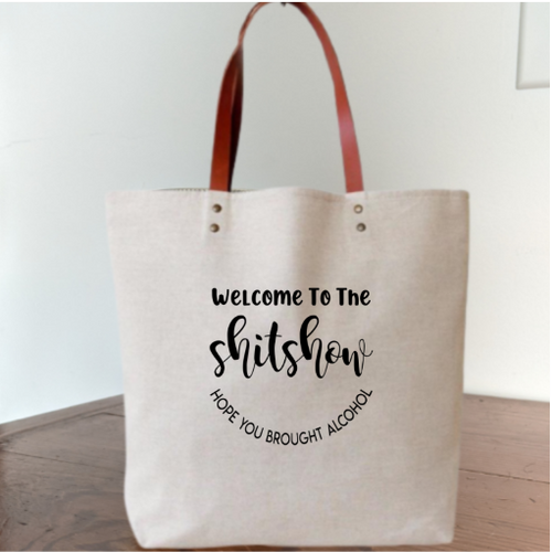 One bag that you'll be carrying around all the time!! Your everyday bag, grocery shopping, farmers market, library bag, book bag & yes, your bag for holding your liquor!!! LOL My favorite is to use these as a gift bag... giving a gift inside a gift. Like liquor!!! :)  Cotton tote bag with light brown faux leather handle. 15